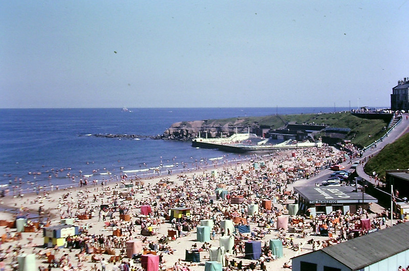 Colour photo of crowds on Longsands beach from the 1960s