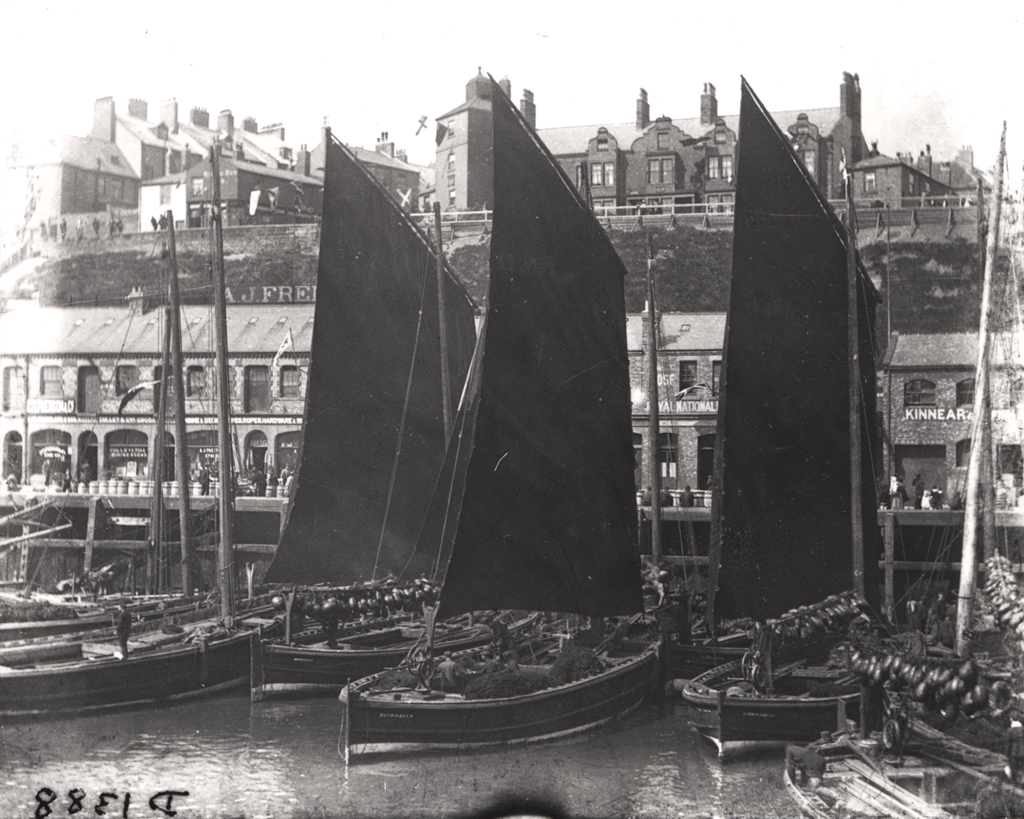 black and white photo of herring boats with sails up on the Fish Quay at North Shields in the 1890s